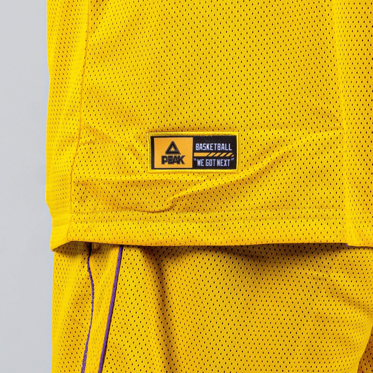 Obojstranná basketbalová súprava (dres + trenírky) PEAK Basketball MATCH REVERSIBLE SET Žlto-fialová